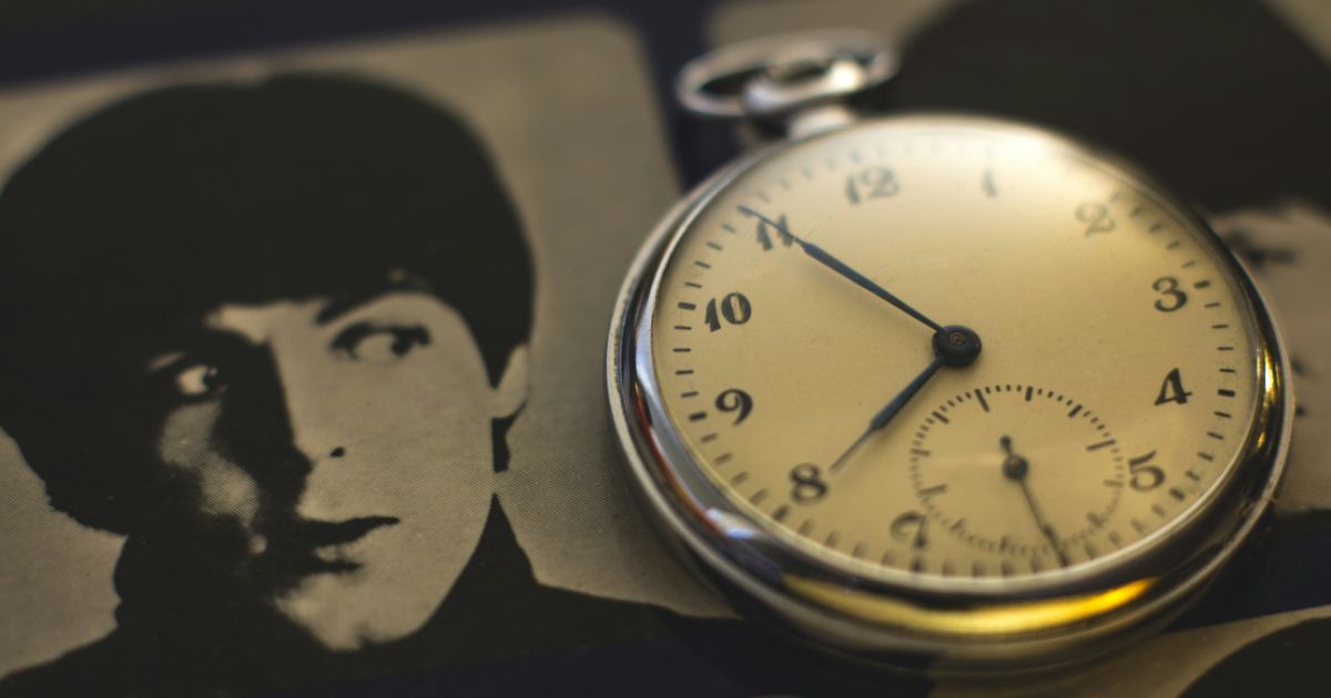 Close-up of a pocket watch on a black and white photograph representing cognitive load in UX.