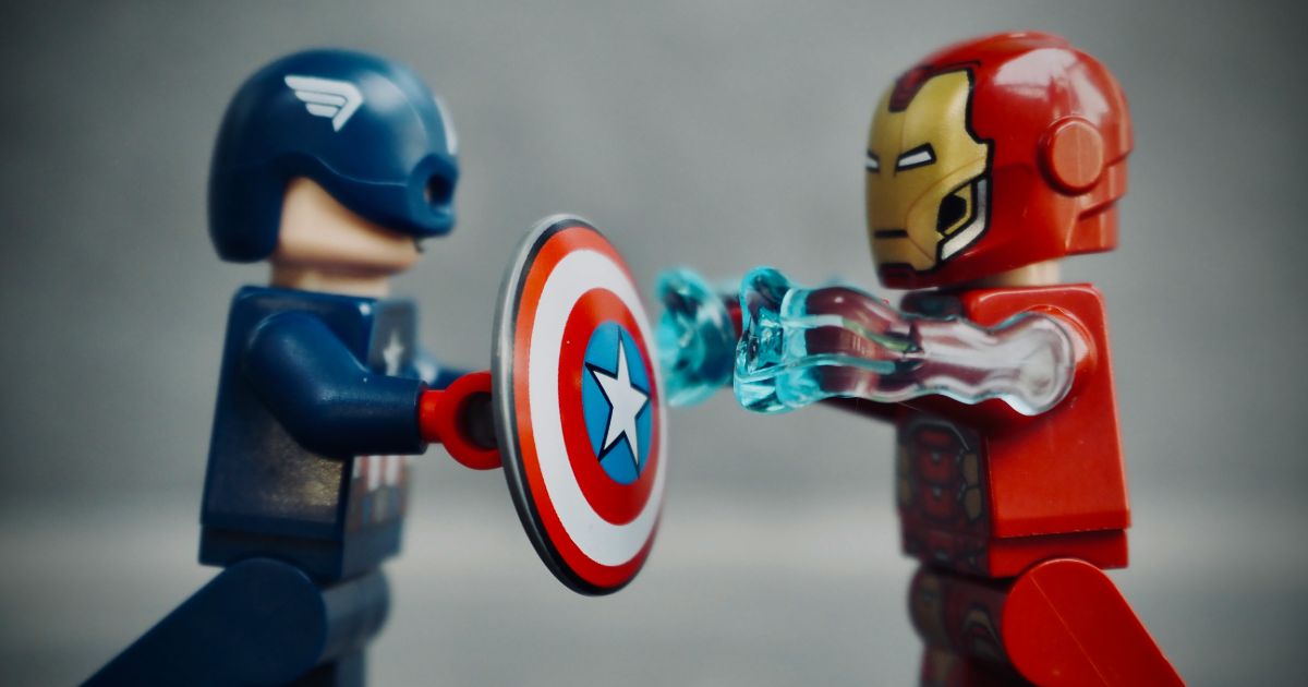 Two LEGO figures depict a playful battle between Captain America and Iron Man, showcasing their iconic superhero rivalry.