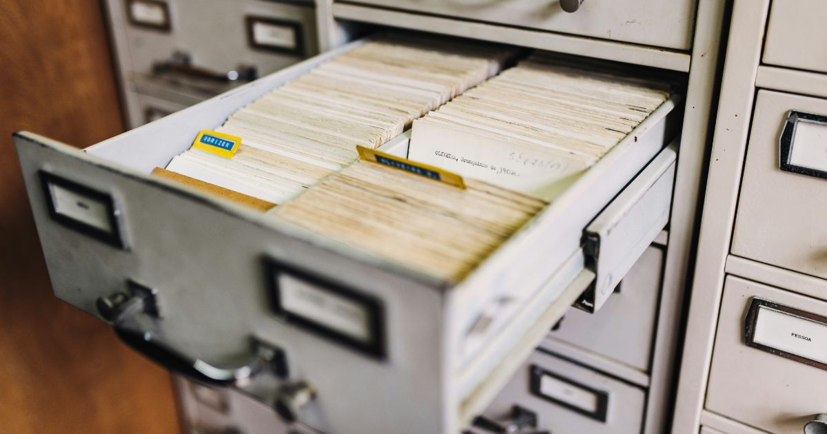 A cluttered drawer filled with neatly organized paper files, showcasing the importance of information architecture in psychology.