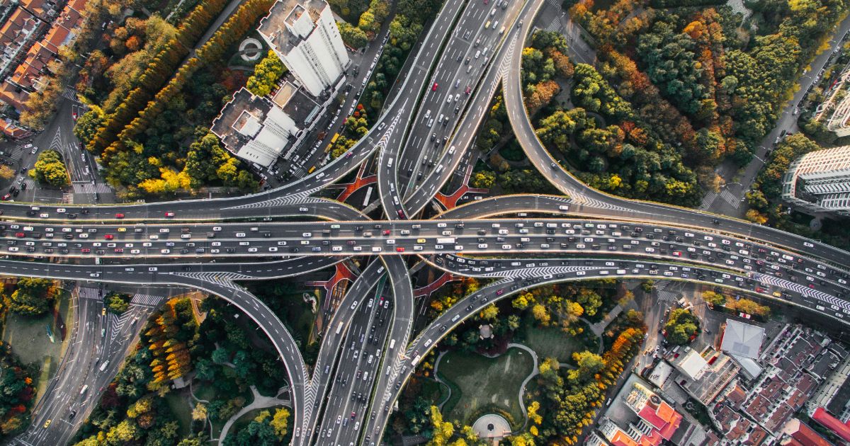 Overhead shot of a highway intersection filled with vehicles, illustrating Triangulation in UX research.