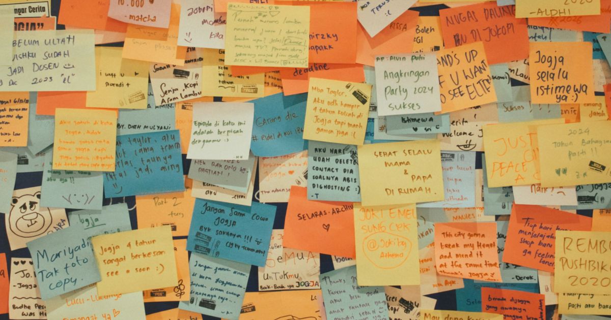 A vibrant wall filled with colorful post-it notes, symbolizing collaboration and accessibility in Agile workflows.