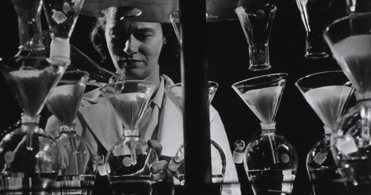 A researcher in a lab, analyzing multiple glasses as part of controlled UX research studies.