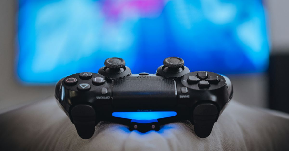 Close-up of a sleek video game controller, highlighting its buttons and design, symbolizing gamification and UX