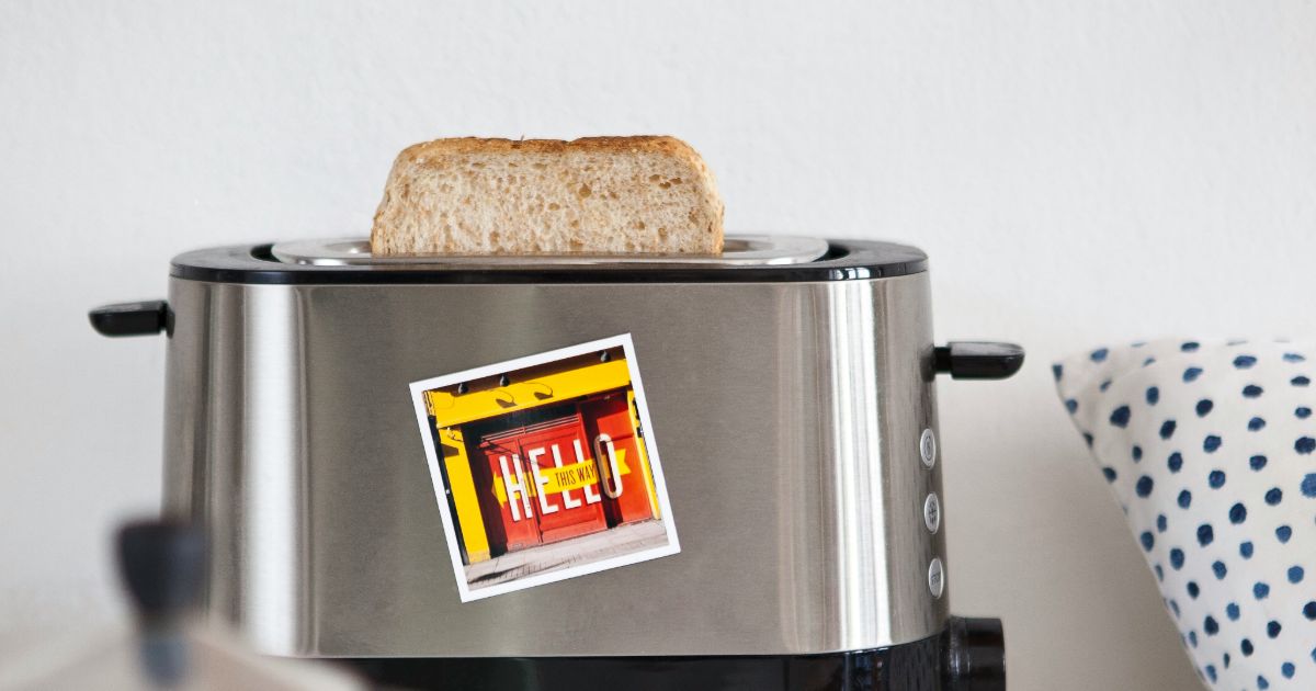 A toaster with a cheerful sticker that says hello prominently displayed on its side representing UX research for IoT.