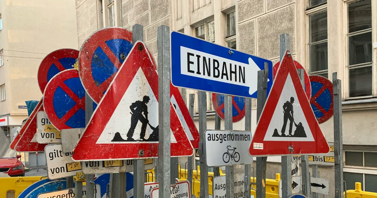 A street sign featuring a man and a woman, indicating a pedestrian crossing or shared space representing invisible accessibility in UX.