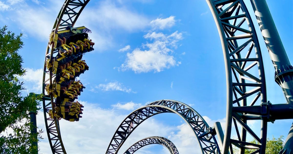 A thrilling roller coaster against a clear blue sky, capturing the excitement of the ride and the beauty of the day and continuous discovery 2.0.