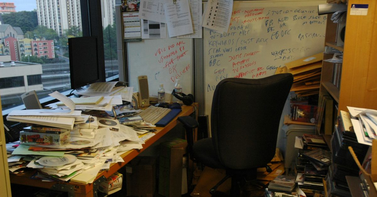 A simple desk with a chair, showcasing a clean workspace ready for productivity representing ux tool bloat.