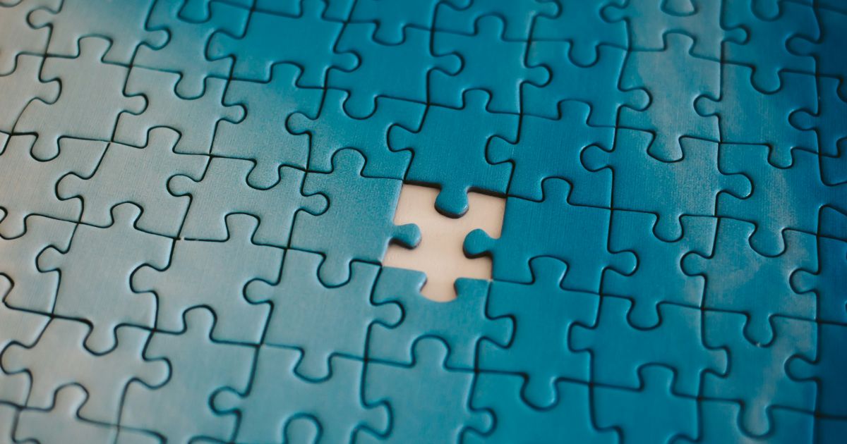 A jigsaw puzzle piece is displayed, highlighting a gap where a piece is missing representing designing for neurodiversity.