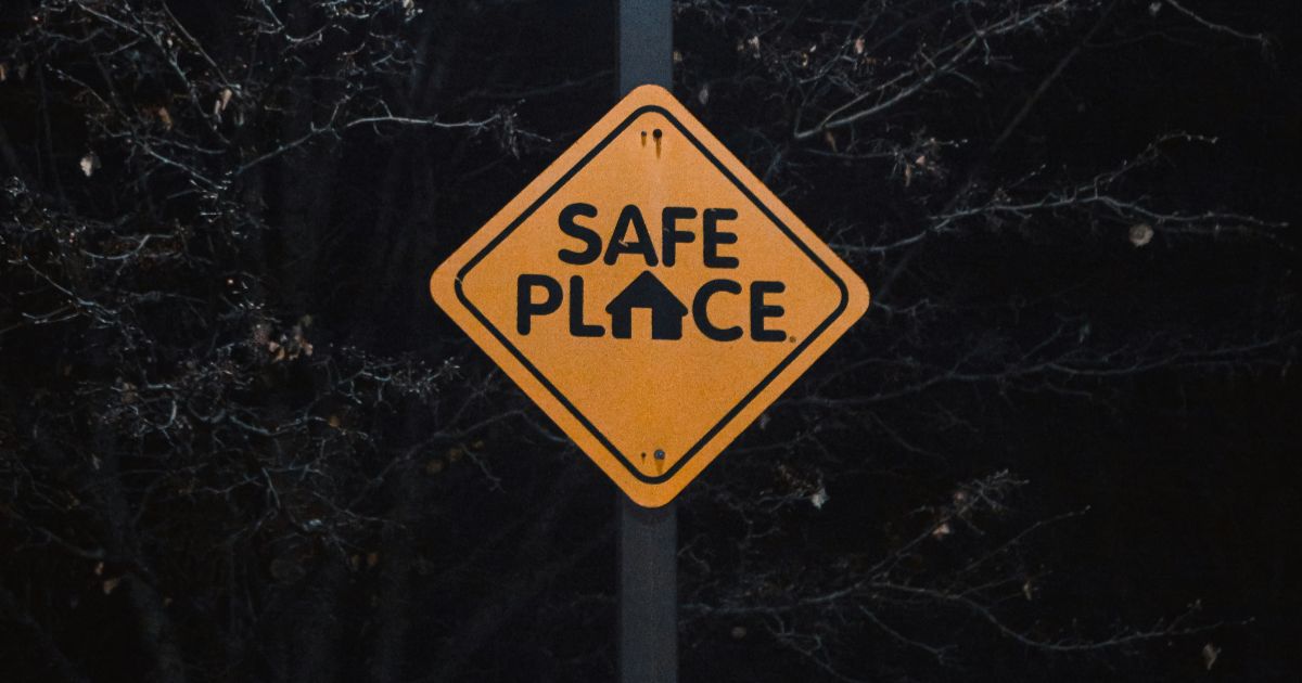 A sign displaying the words Safe Place in bold letters against a neutral background representing psychological safety in digital spaces.