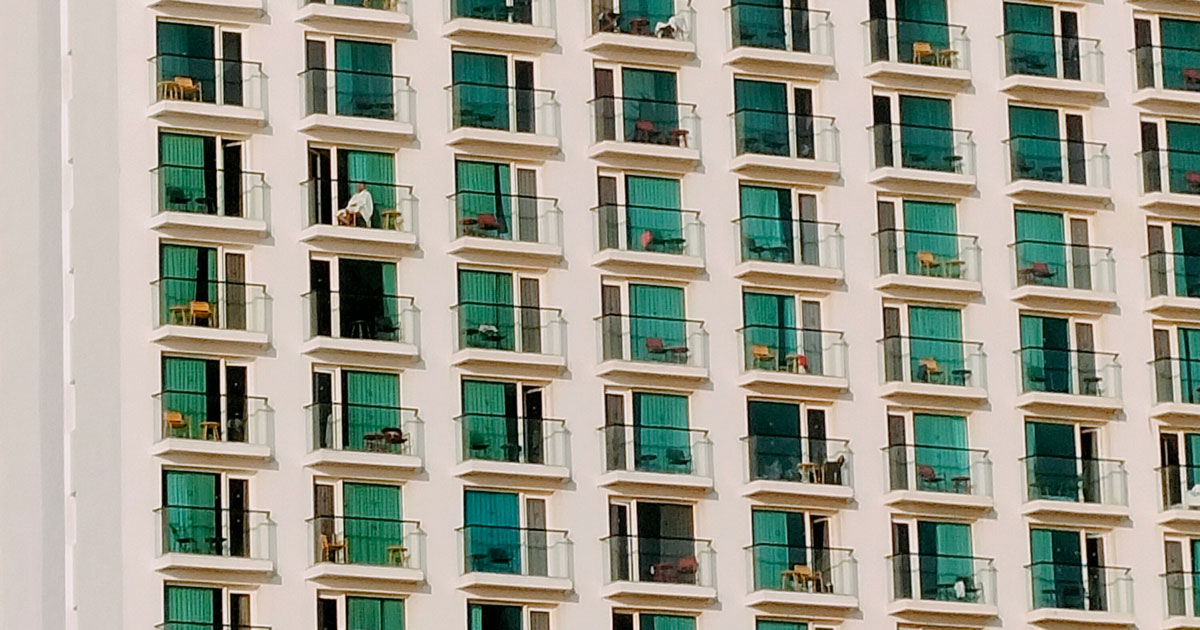 A multi-story building featuring numerous windows and balconies, showcasing shared UX design patterns in its architecture.